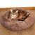 Brown Springos round pet bed with cat sleeping in it