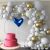 Springos balloon arch decoration with white and gold balloons, cake, and heart balloon for birthday party.
