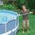 Person using Intex pool leaf skimmer to clean debris from the surface of their pool
