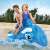 Two children riding Intex inflatable whale rider on a beach