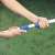 Close-up of hands adjusting the telescopic pole of the Intex pool cleaning kit