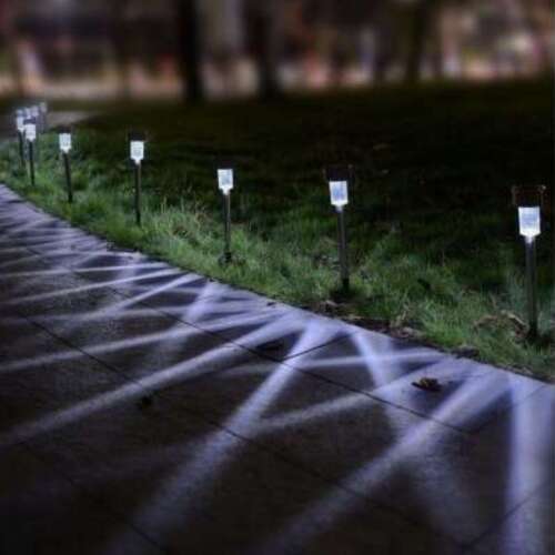 Polifach LED solar garden lamp illuminating a pathway at night