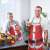 Two men wearing Santa Claus aprons, holding drinks
