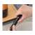 Hand holding a black pneumatic wine opener
