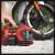 Einhell PRESSITO 18/21 cordless air compressor, red, being used to inflate a motorcycle tire
