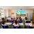 Epson EB-982W projector in classroom setting, displaying educational content