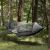 Springos gray camping hammock with mosquito net hanging between trees