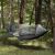 Springos gray camping hammock with mosquito net hanging between trees