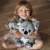 A girl holding the Mokki and Lulu interactive plush koala toy set