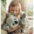 A girl holding the Mokki and Lulu interactive plush koala toy set