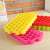 Stack of colorful silicone ice cube trays, hexagonal molds, close-up