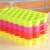 Stack of colorful silicone ice cube trays, hexagonal molds