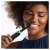 Woman using Oral-B iO Series 4 electric toothbrush, black