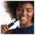 Woman using Oral-B iO Series 4 electric toothbrush, black