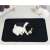 Black quilted dog pee pad with a dog sleeping on it