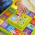 Close-up of baby hand interacting with Fisher-Price Laugh & Learn Activity Board