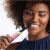 Woman using Oral-B iO Series 5 Pink Electric Toothbrush