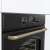 Gorenje BOS67372CLB built-in oven, black with gold handle, close-up of control panel