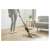 Woman using Sencor SVC 0607CH cordless stick vacuum cleaner on hardwood floor
