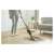 Woman using Sencor SVC 0607CH cordless stick vacuum cleaner