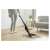 Woman using Sencor SVC 0608BK cordless stick vacuum cleaner on hardwood floor