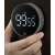 Hand holding the black magnetic digital kitchen timer with the display showing 99:55
