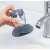 Mercaton® dish brush with soap dispenser, showing how to use it in the sink