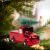 Red toy truck Christmas ornament with tree on Christmas tree