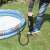 Person using Bestway Air Hammer foot pump to inflate an inflatable pool