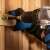 Blaupunkt BP6310AC cordless drill in use, screwing a screw into wood