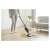 Woman using Sencor SVC 0618TI cordless stick vacuum cleaner on a wooden floor