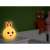 Tracer Bunny night light with warm white light, on a nightstand in a bedroom