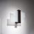 FENIKS wenge wall light illuminating a wall