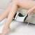 Woman using Soulima slimming massager on leg