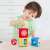 Child playing with the Hola Stack 'N Sort Tower toy, sorting balls into the blocks