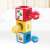 Hola Stack 'N Sort Tower toy, showing the red, yellow, and blue blocks stacked together with the balls in a living room setting