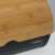 Close-up of bamboo lid on black enamel bread bin, Cookline brand