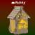 Ruhhy Christmas LED lantern, lit up, wooden house shaped, with a rope handle, showing the nativity scene design