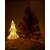 White wicker Christmas tree with warm white LED lights, lit up in a room