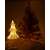 White wicker Christmas tree with warm white LED lights, 39cm tall, lit, next to a larger Christmas tree
