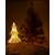 White wicker Christmas tree with warm white LED lights, 39cm tall, lit, next to a larger Christmas tree